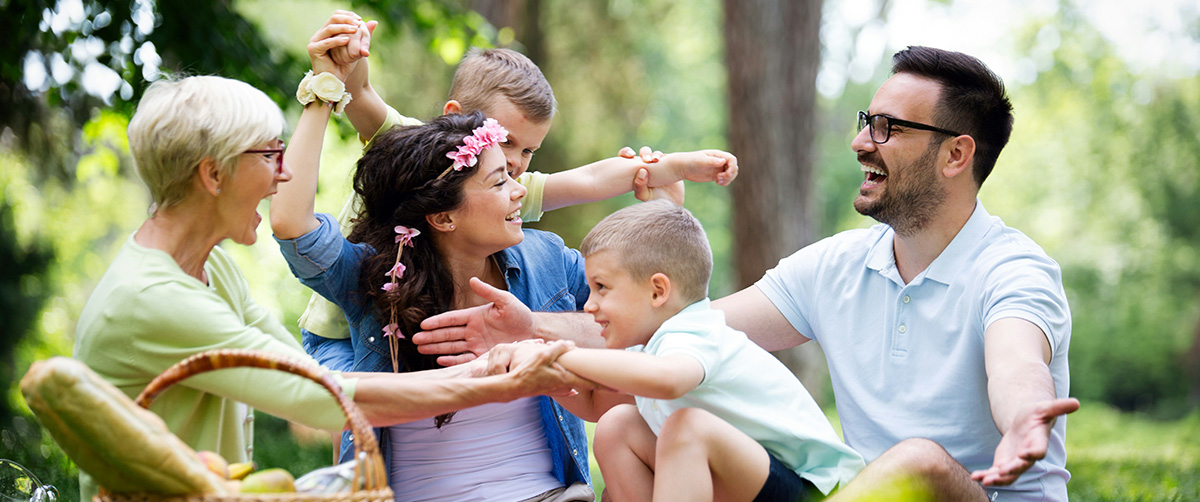 A family enjoying their time together in field surrounded by trees