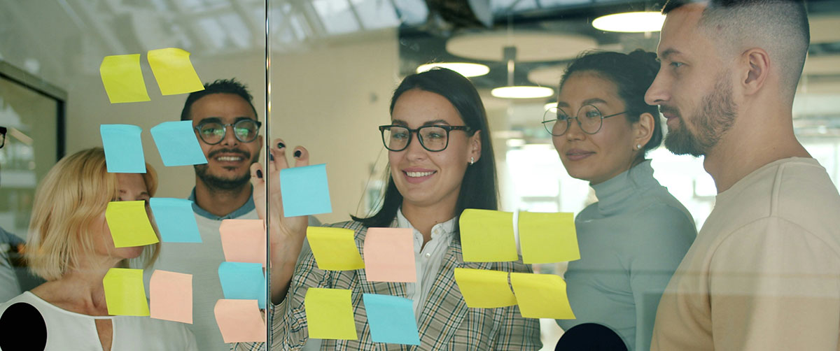 A group of people in discussion using sticky notes to organize ideas