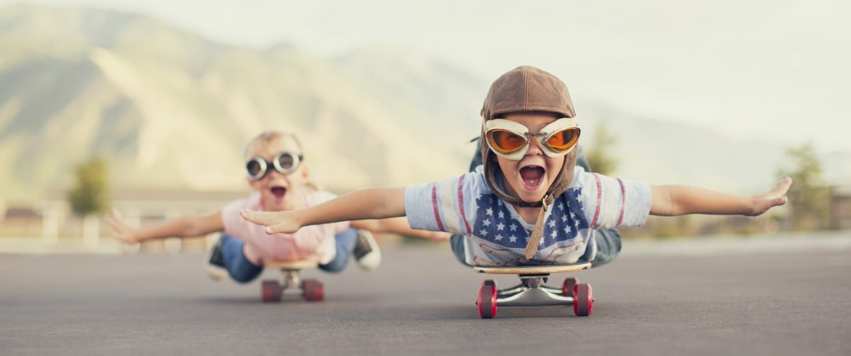 Young Boy and Girl Imagine Flying On Skateboard