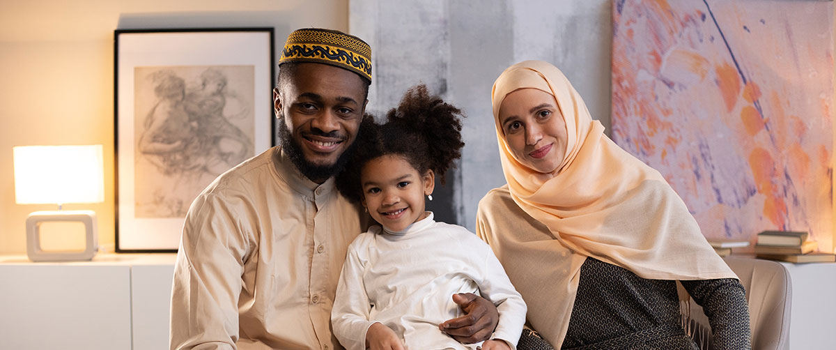 A Muslim family sitting in their home
